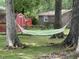 A serene backyard featuring a hammock strung between mature trees, creating a perfect spot for relaxing outdoors at 104 Jackson Rd, Ladson, SC 29456