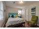 Serene bedroom features a queen-sized bed, hardwood floors, and neutral walls, perfect for restful nights and relaxation at 104 Jackson Rd, Ladson, SC 29456