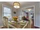Inviting dining room with seating for four, featuring a decorative light fixture and seamless flow to the living area at 104 Jackson Rd, Ladson, SC 29456