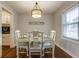 Charming dining area with a wooden table set for four, adorned with a decorative chandelier and natural light at 104 Jackson Rd, Ladson, SC 29456