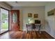 Welcoming foyer with an office space featuring hardwood floors and stylish decorations with a wood door at 104 Jackson Rd, Ladson, SC 29456