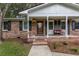 Inviting front porch with brick steps, decorative bench, and a stylish front door with glass detail at 104 Jackson Rd, Ladson, SC 29456