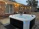 Inviting backyard hot tub with exterior lighting, set on a patio near the home, creating an ideal spot for relaxation at 104 Jackson Rd, Ladson, SC 29456