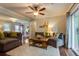 Bright living room with hardwood floors, plush seating, and a sliding glass door that fills the space with natural light at 104 Jackson Rd, Ladson, SC 29456