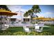 Exterior scene with yellow umbrellas, tables, chairs, and lush landscaping in front of the clubhouse at 105 Barker Street, Summerville, SC 29486