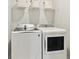 Well-equipped laundry room with a washer, dryer, and storage shelf at 105 Barker Street, Summerville, SC 29486