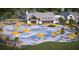 Aerial view of community pool and clubhouse with poolside seating, loungers, umbrellas and beautiful landscaping at 105 Barker Street, Summerville, SC 29486