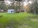 Spacious backyard with a shed, grassy lawn, mature trees and ample space for outdoor activities at 106 Labrador Ct, Summerville, SC 29485