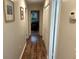 Inviting hallway with wood-look floors, neutral walls, and ample closet space for storage at 106 Labrador Ct, Summerville, SC 29485