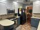 Kitchen with stainless steel appliances, two-tone cabinets, and brick-patterned flooring at 106 Labrador Ct, Summerville, SC 29485