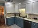 Well-lit kitchen featuring two-tone cabinets, modern appliances, and brick-patterned flooring at 106 Labrador Ct, Summerville, SC 29485