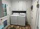 Cozy laundry room featuring white cabinets, a washer and dryer, and a door to the backyard at 106 Labrador Ct, Summerville, SC 29485