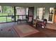 Relaxing screened porch features comfortable seating, a rug, and outdoor views, perfect for leisure at 106 Labrador Ct, Summerville, SC 29485