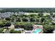 An aerial view shows the community with a pond, pool, tennis court and homes surrounded by lush trees at 1075 Wayfarer Ln, Charleston, SC 29412