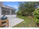 Beautiful backyard featuring patio, lush green space, and screened-in back porch at 1075 Wayfarer Ln, Charleston, SC 29412
