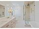 Luxurious bathroom with double vanities, a walk-in shower, and a freestanding bathtub, offering a spa-like experience at 1075 Wayfarer Ln, Charleston, SC 29412