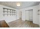 Bright bedroom with wood floors, floral wallpapered ceiling, closet, and modern shelving at 1075 Wayfarer Ln, Charleston, SC 29412