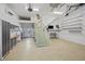 Spacious garage featuring epoxy floor, stairs, custom storage, and organization system at 1075 Wayfarer Ln, Charleston, SC 29412