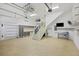 Bright garage with an epoxy floor, stairs, custom storage, organization system, and ample space at 1075 Wayfarer Ln, Charleston, SC 29412