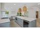 Gourmet kitchen with stainless steel appliances, wine cooler, large island, and pendant lights at 1075 Wayfarer Ln, Charleston, SC 29412