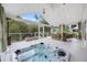 Inviting covered patio featuring a hot tub, ceiling fan, and comfortable wicker seating at 1075 Wayfarer Ln, Charleston, SC 29412