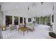 Covered patio boasting comfortable wicker furniture, ceiling fan, and a luxurious hot tub at 1075 Wayfarer Ln, Charleston, SC 29412