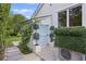 A private entrance to the home featuring manicured greenery and a decorative, light blue door at 1075 Wayfarer Ln, Charleston, SC 29412