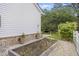 Charming side yard with a garden bed and a white picket fence, creating a cozy outdoor space at 1075 Wayfarer Ln, Charleston, SC 29412