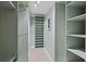 Well-organized walk-in closet with built-in shelving and ample storage space for clothing and accessories at 1075 Wayfarer Ln, Charleston, SC 29412