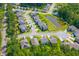An aerial view of a suburban neighborhood with houses, green lawns, and a community pond at 108 Rusting Link Rd, Summerville, SC 29483