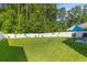 Beautiful backyard with a well-kept lawn, white fence, and ample space for outdoor activities and landscaping at 108 Rusting Link Rd, Summerville, SC 29483