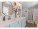 Elegant bathroom featuring a double vanity, stylish mirrors, and a glass-enclosed shower at 108 Rusting Link Rd, Summerville, SC 29483