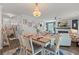 Charming dining room with a decorative chandelier, open floor plan, and stylish furnishings at 108 Rusting Link Rd, Summerville, SC 29483