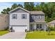 Charming two-story home featuring gray and white siding, a well-maintained lawn, and an attached two-car garage at 108 Rusting Link Rd, Summerville, SC 29483
