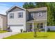 Charming two-story home featuring gray and white siding, a well-maintained lawn, and an attached two-car garage at 108 Rusting Link Rd, Summerville, SC 29483