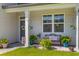 Inviting front porch with bench, flower pots, and decorative hanging plants, creating a cozy outdoor space at 108 Rusting Link Rd, Summerville, SC 29483