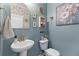 Charming powder room featuring a pedestal sink, decorative mirror, and stylish wall decor at 108 Rusting Link Rd, Summerville, SC 29483