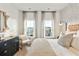 Comfortable bedroom with two windows, black dresser, white chair, and stylish headboard at 109 Barker Street, Summerville, SC 29486