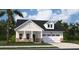 Charming one-story home featuring white siding, a covered front porch, and an attached two-car garage at 109 Barker Street, Summerville, SC 29486