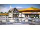 Resort-style pool with lounge chairs, umbrellas, and clubhouse in the background at 109 Barker Street, Summerville, SC 29486