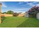 A backyard with a wood fence, green grass, purple flowers, and an outdoor shed at 109 Dovetail Cir, Summerville, SC 29483
