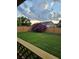 A beautiful backyard with lush green grass, a wooden fence and a beautiful Crape Myrtle tree at 109 Dovetail Cir, Summerville, SC 29483
