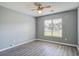 Bright bedroom featuring a ceiling fan, wood-look flooring and a view to the neighborhood at 109 Dovetail Cir, Summerville, SC 29483