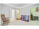 Bright bedroom with a rocking chair and a built-in bookshelf with a walk-in closet at 1111 Basildon Rd, Mount Pleasant, SC 29466