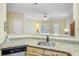 Kitchen featuring granite countertops, wooden cabinetry, and stainless steel dishwasher with a view into the living room at 1111 Basildon Rd, Mount Pleasant, SC 29466
