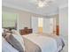 Comfortable main bedroom features a ceiling fan, large window, ensuite bath, and large closet at 1111 Basildon Rd, Mount Pleasant, SC 29466
