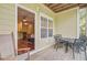 Outdoor porch with seating and a view into the property's living room at 1111 Basildon Rd, Mount Pleasant, SC 29466