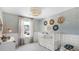 Beautiful Bedroom with a white crib, decorative wallpaper, and natural light from a window at 113 Moscato Ln, Summerville, SC 29485