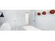 A modern bedroom featuring a bed, sports decor, and an open door showcasing the interior at 113 Moscato Ln, Summerville, SC 29485