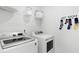 Well-organized laundry room with modern washer and dryer, plus storage and cute 'lost socks' sign at 113 Moscato Ln, Summerville, SC 29485